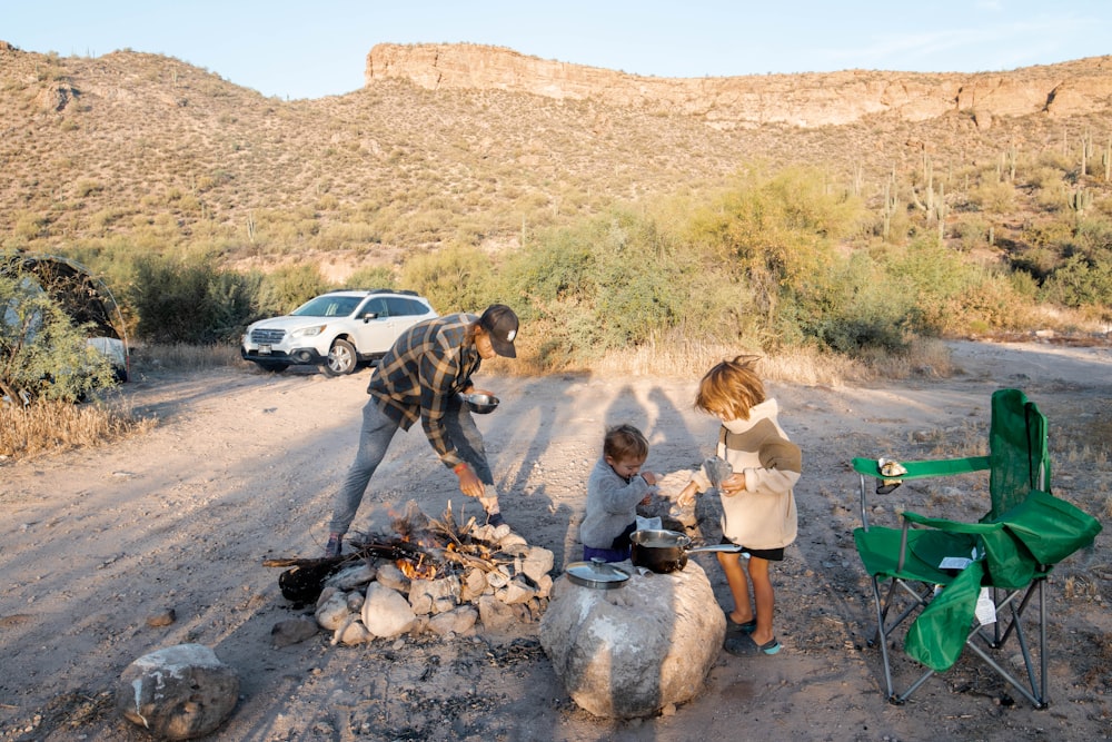 a man and a woman cooking outside