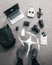 a laptop and mobile phones drone travel resources and gearson the floor