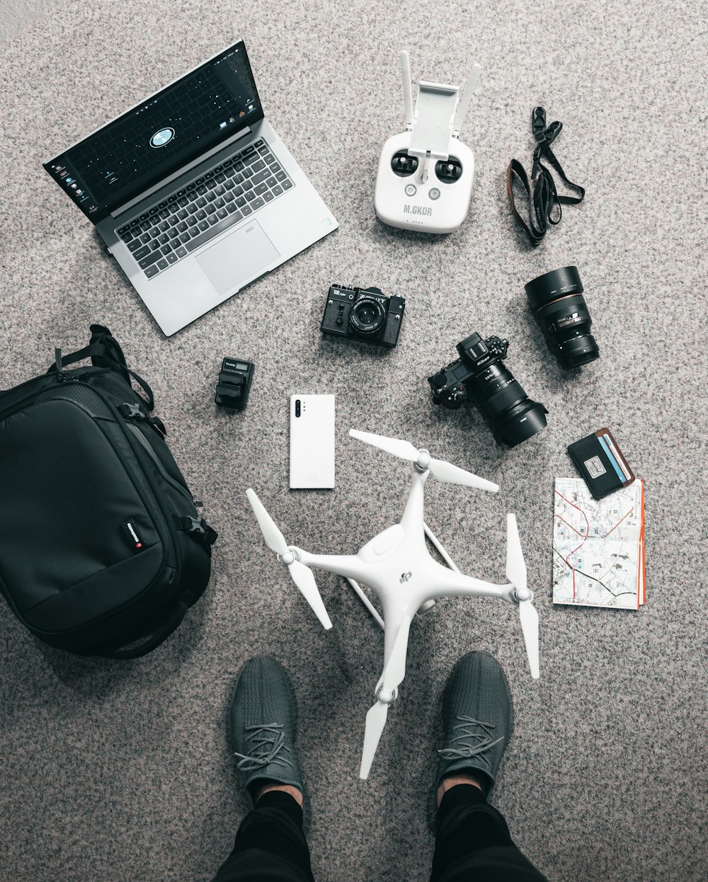 a laptop and mobile phones on the floor