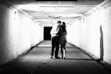 a man and woman kissing in a tunnel