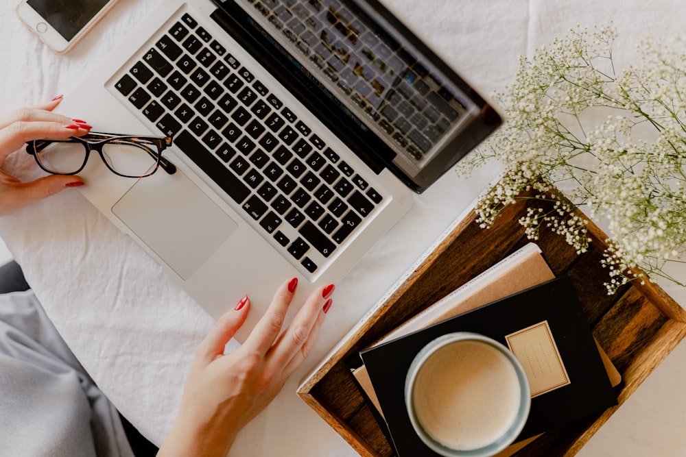 a woman's hand on a laptop