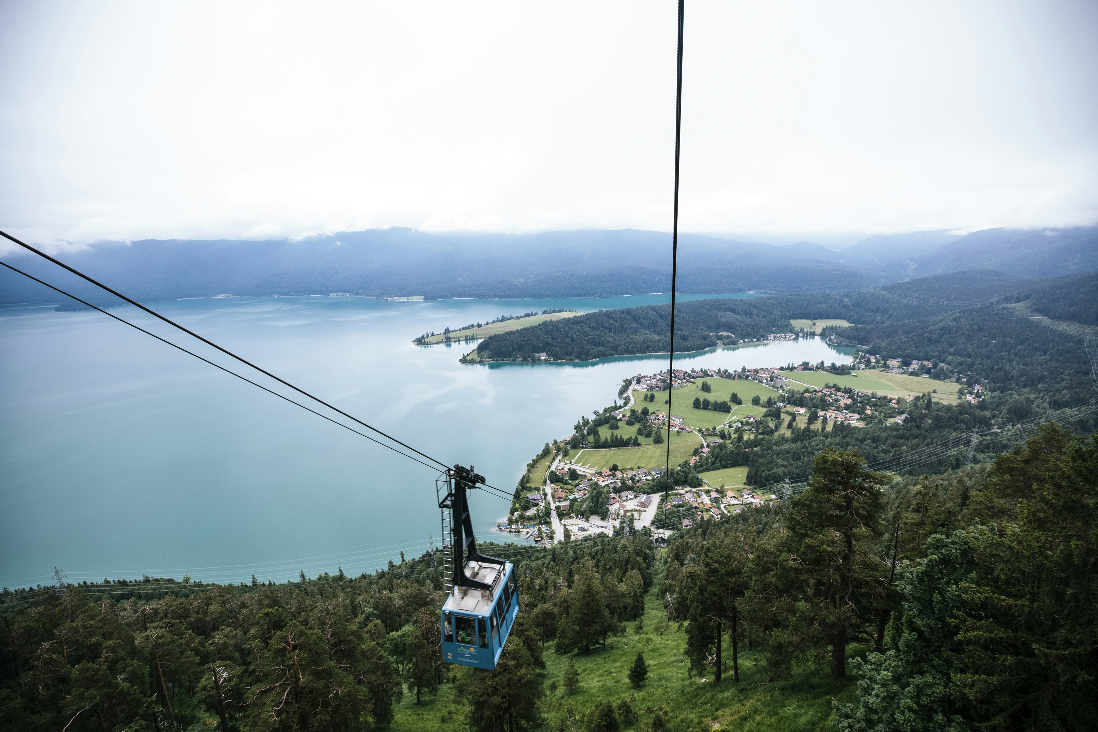a view of a mountain, Walchensee is one of the deepest (190 m) and at the same time one of the largest (16.40 km²) alpine lakes in Germany.