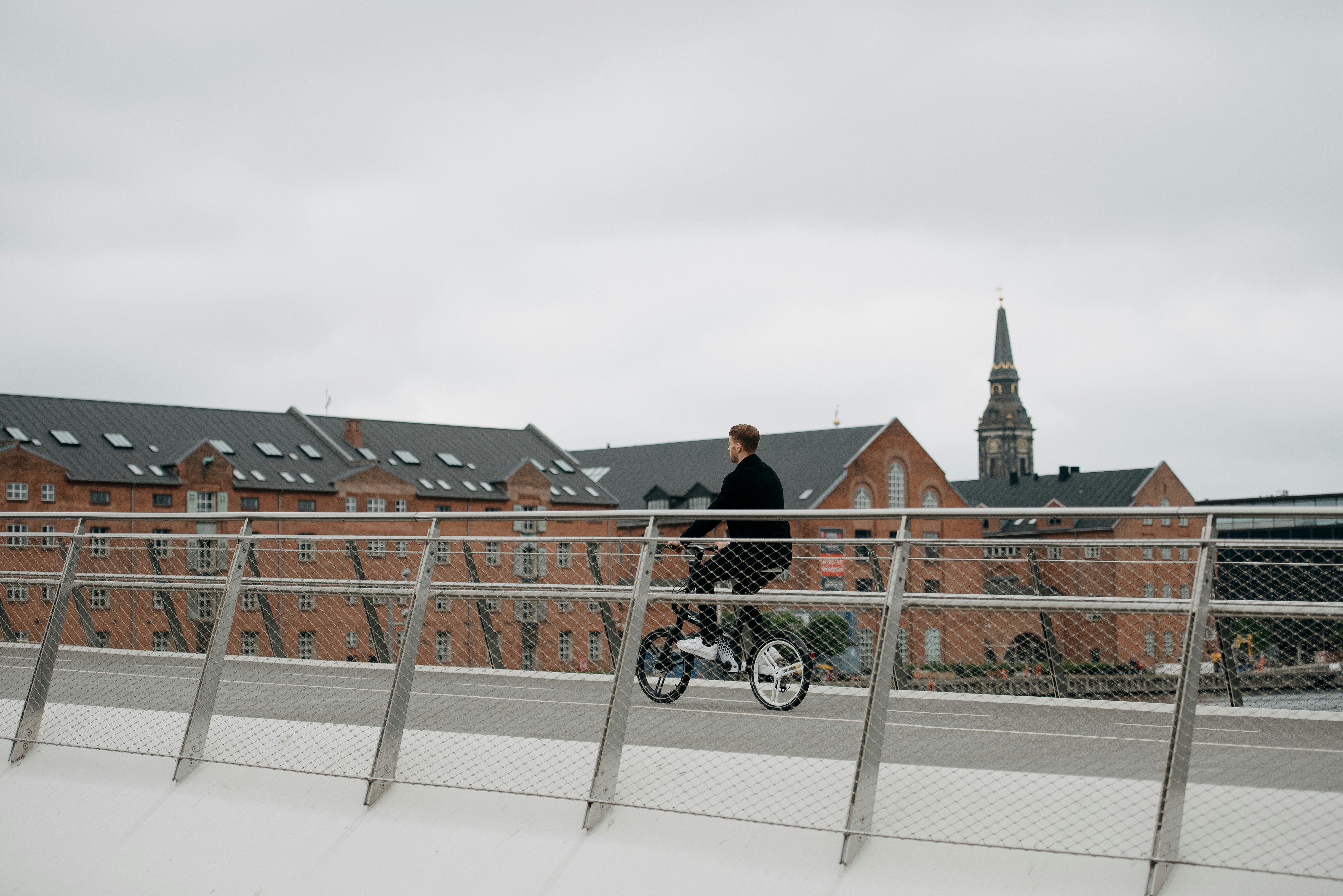 a person riding a bicycle on a bridge