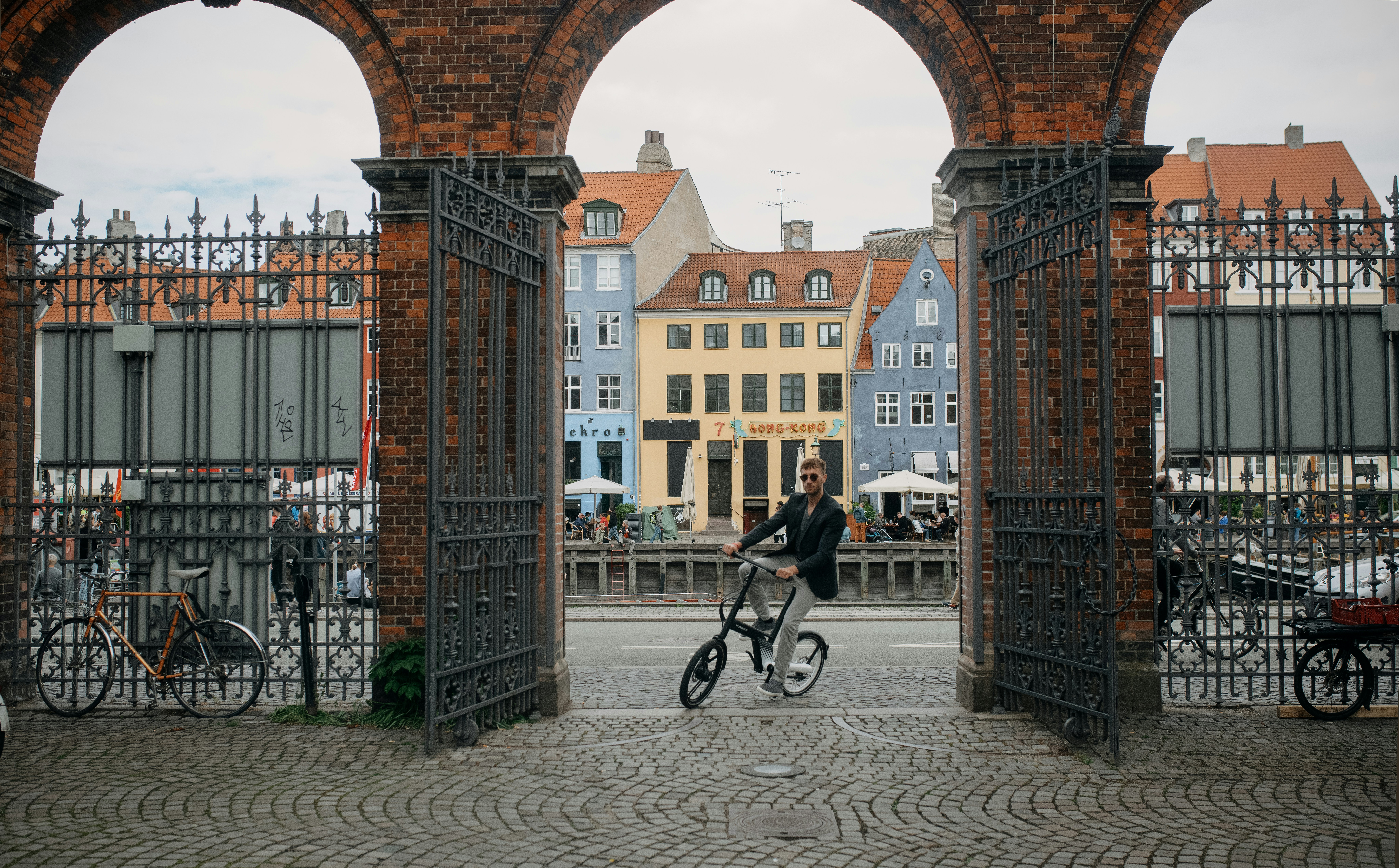 a person riding a bicycle under a bridge