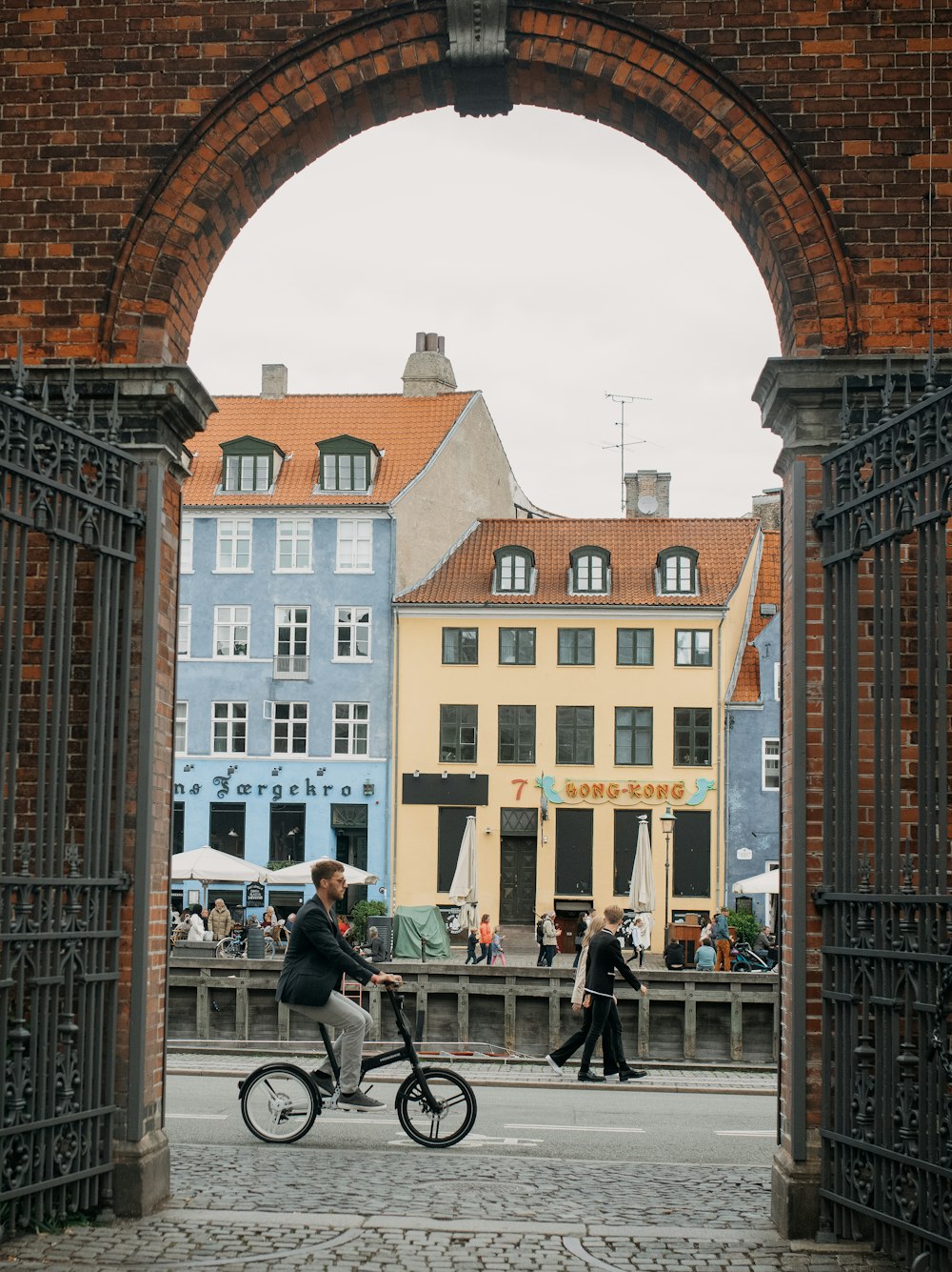 a person riding a bicycle under a bridge