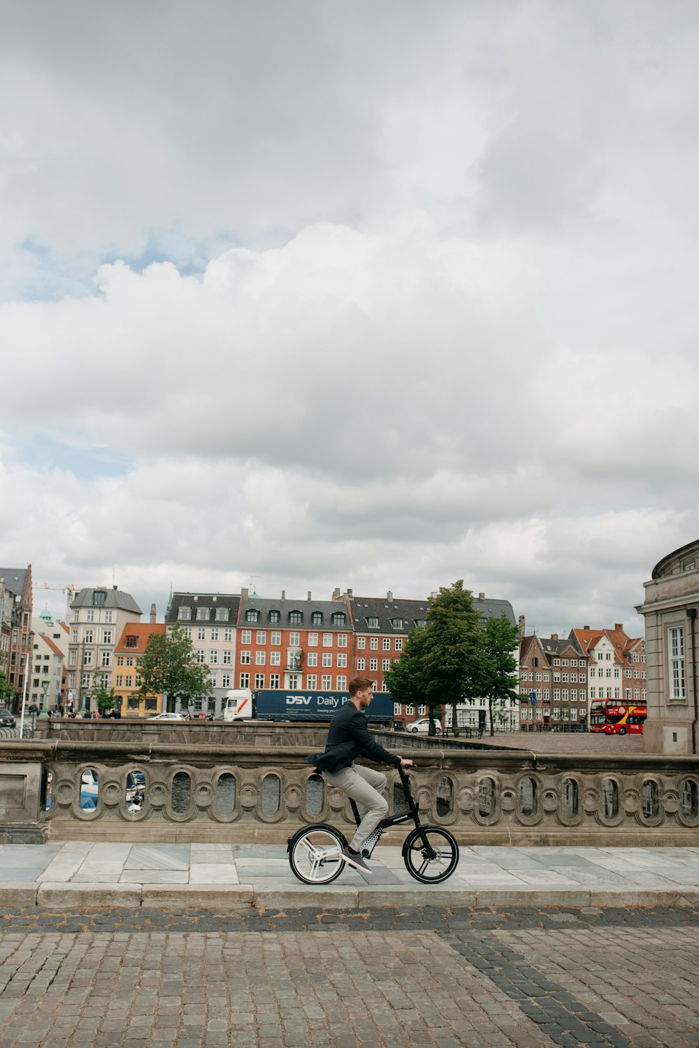 a person riding a bicycle on a bridge over a river