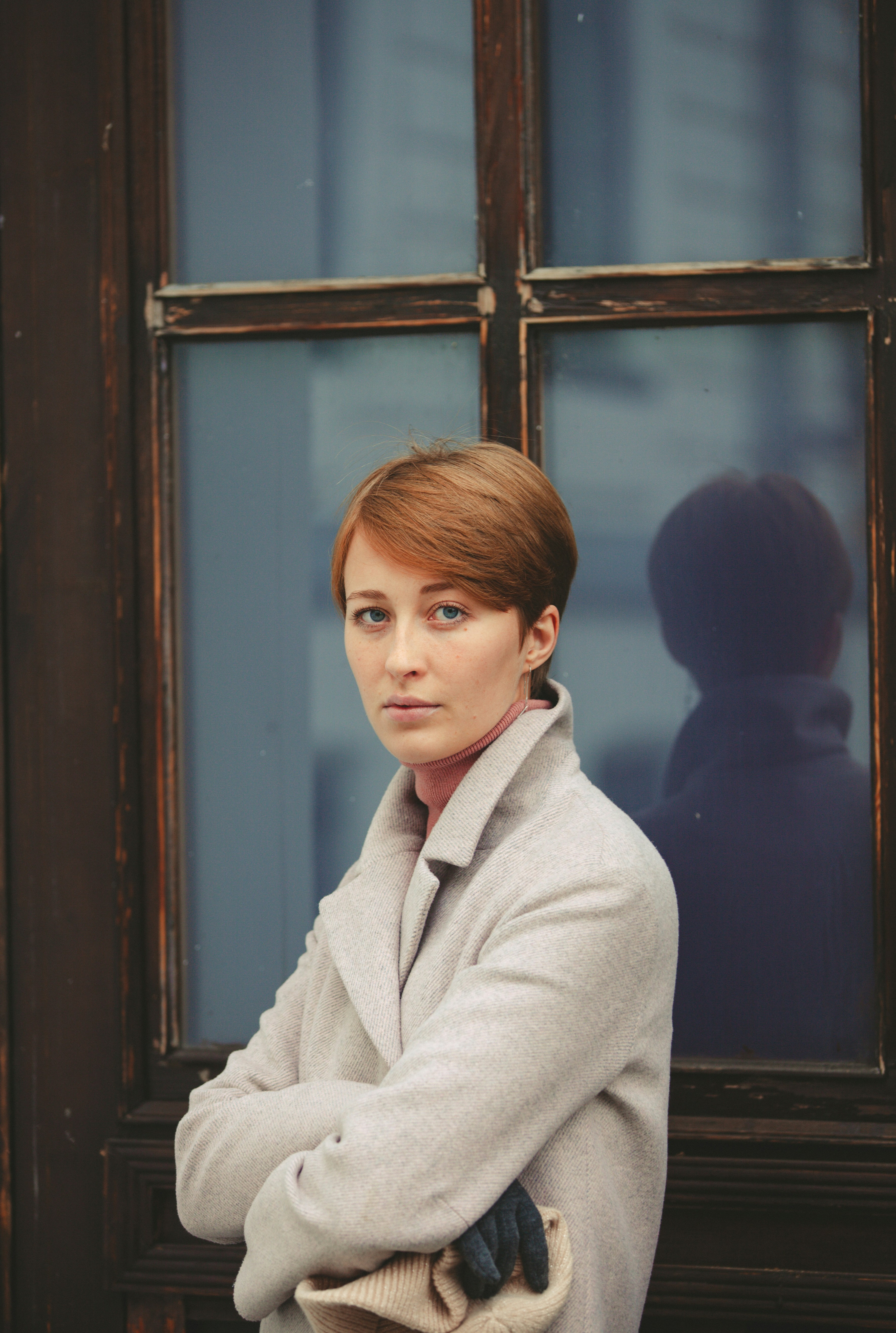 a woman leaning against a window