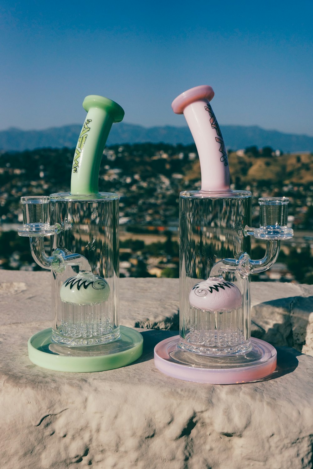 a group of glass vases with a toothbrush in them with Stratosphere Las Vegas in the background