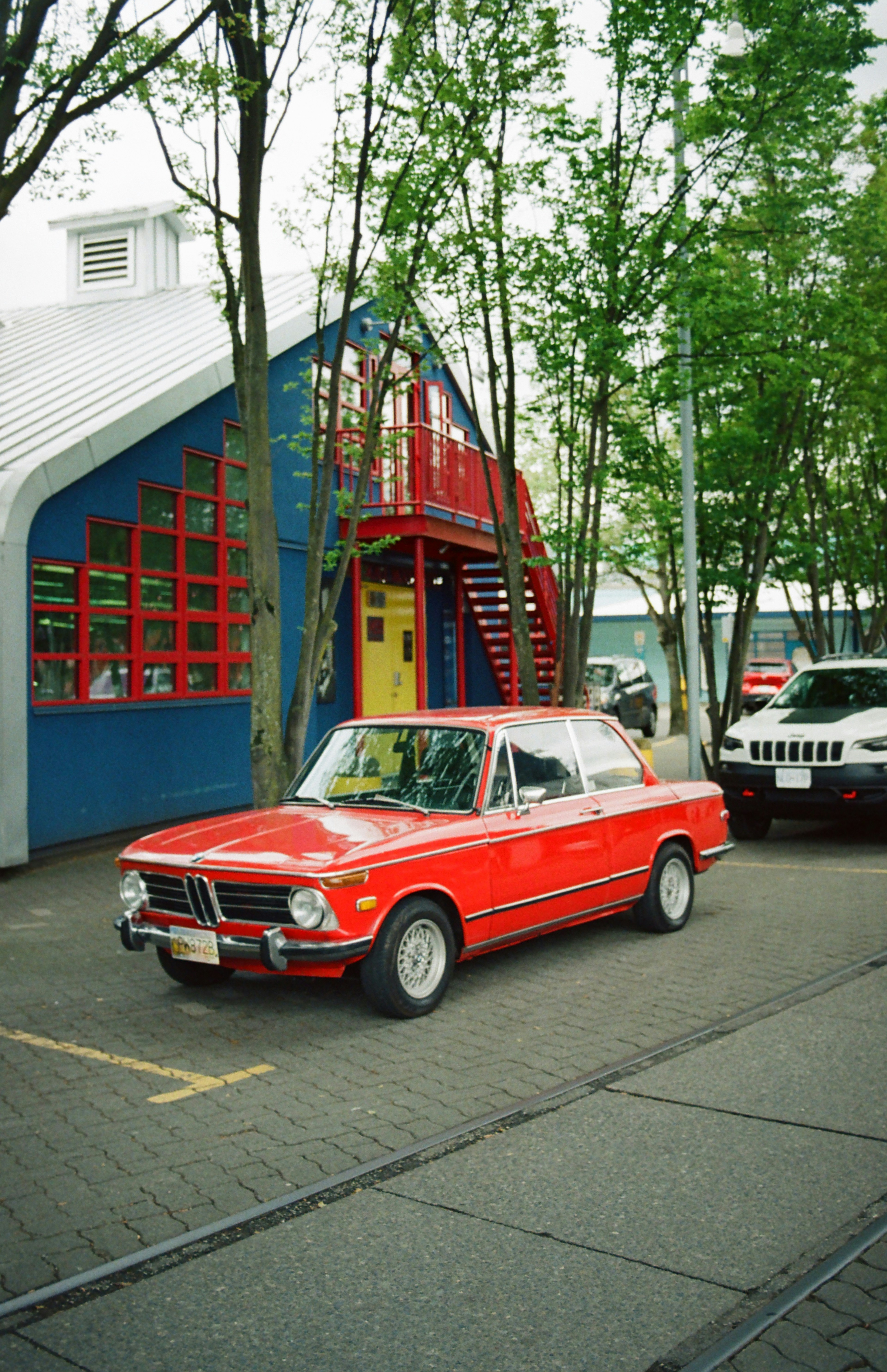 A red car parked in front of a building photo – Free Canada Image on ...