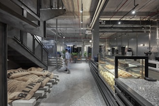 a person walking in a large room with food on display