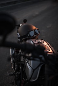 Artistic shot of a vintage racing helmet resting on a polished wooden table with soft natural light.