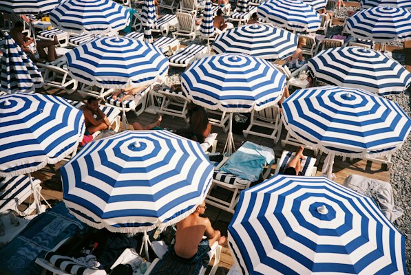 People sitting under umbrellas — Nice, France