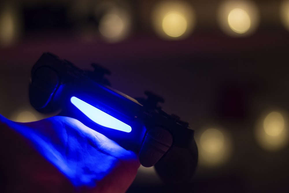 a hand holding a blue light