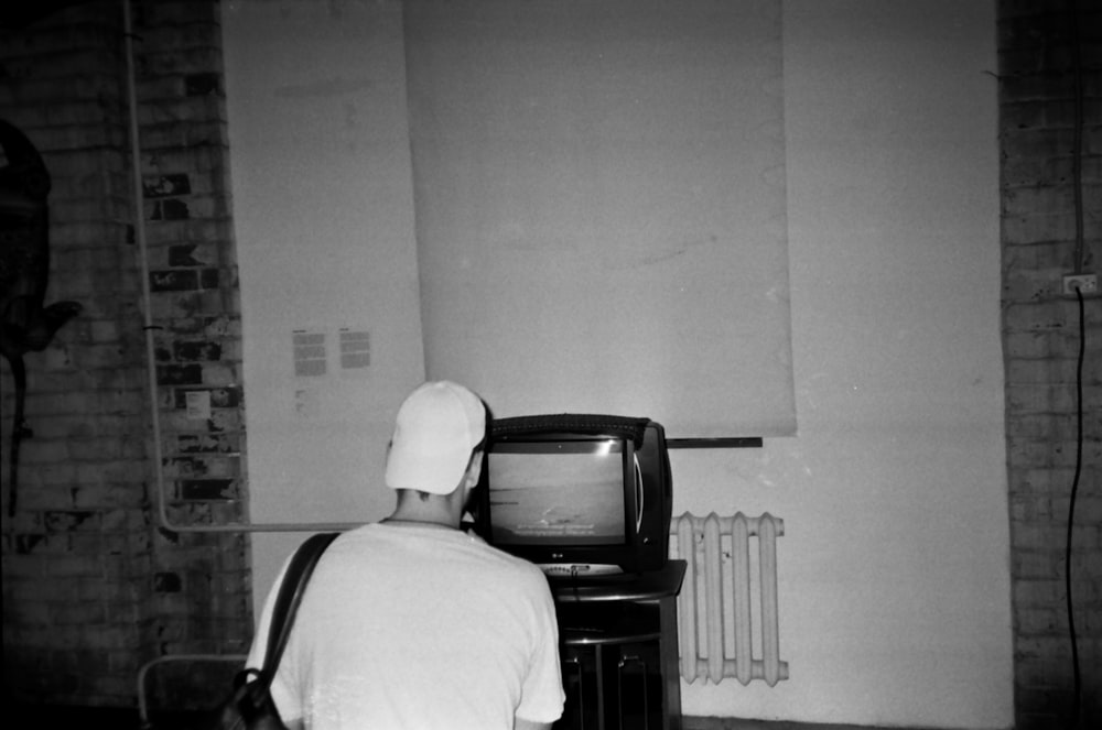 a person sitting in front of a television