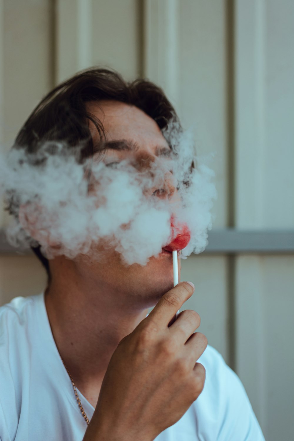 a person holding a white substance in the mouth