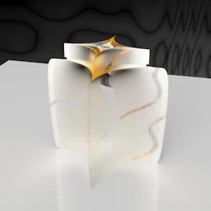 Handmade resin sculpture with subtle golden hues displayed on a smooth, creamy surface.