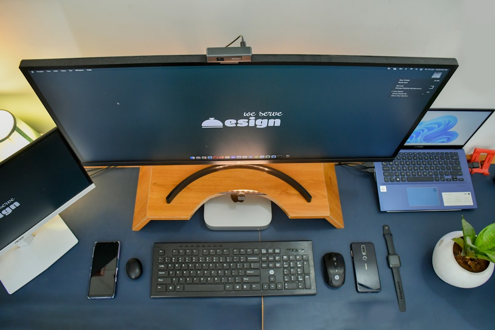 a desk with a computer and a phone