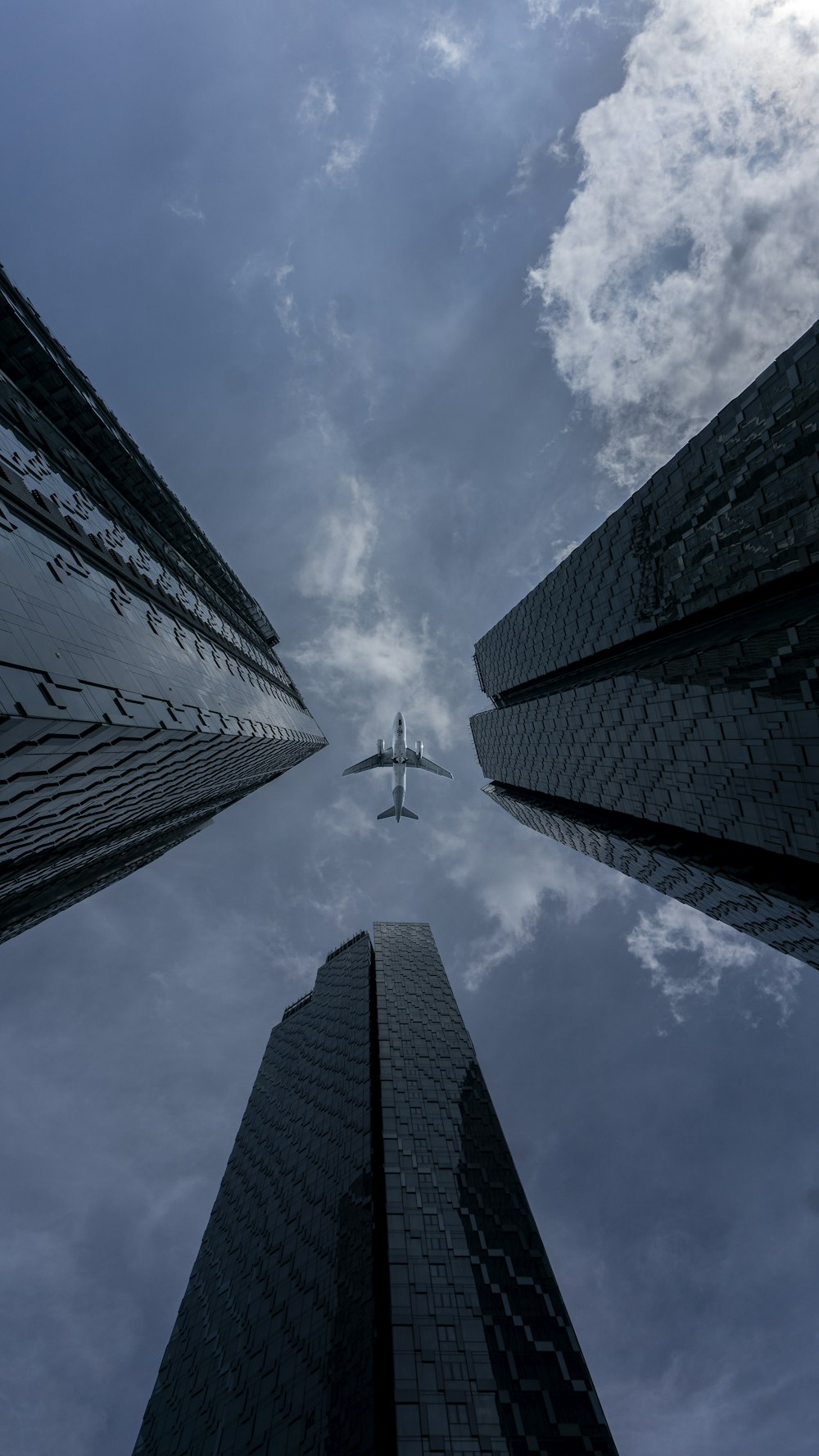 a helicopter flying between two tall buildings