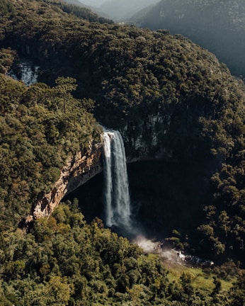 a waterfall with a mountain in the background