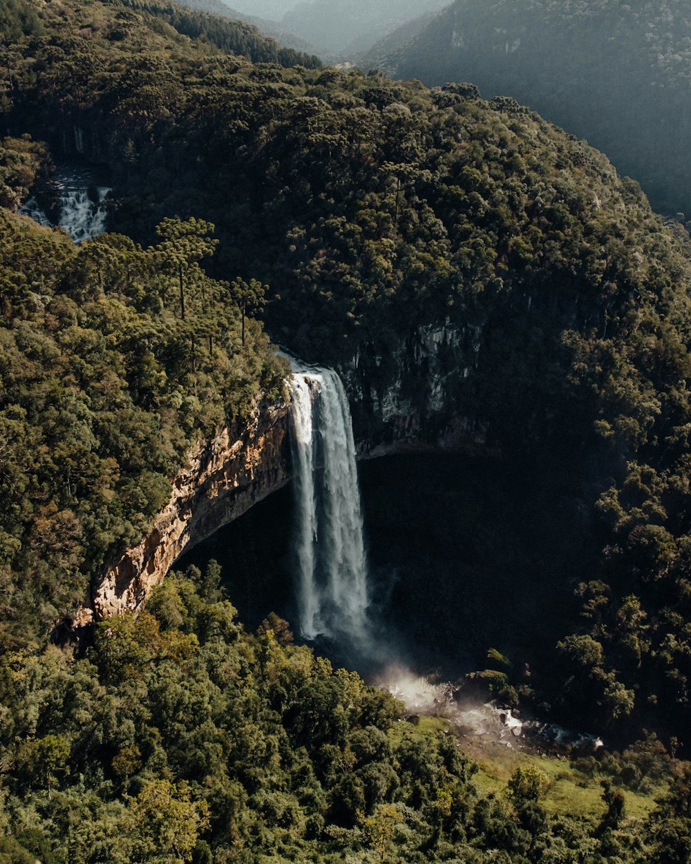 a waterfall with a mountain in the background