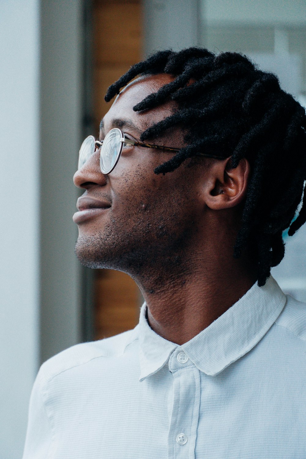 a man wearing glasses and looking at the camera