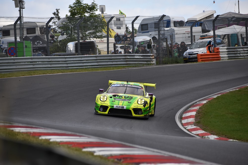 a green race car on a track