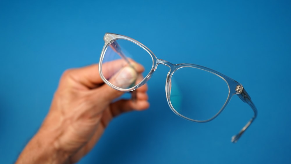 a hand holding a magnifying glass