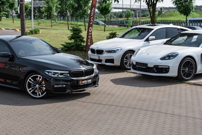 a group of cars parked on a brick road