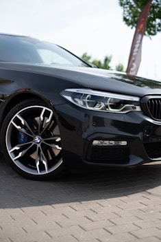 a black car parked on a brick road