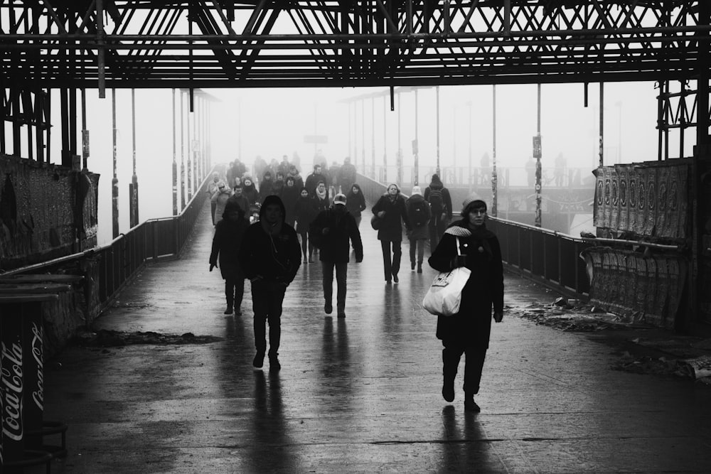 a group of people walking on a bridge