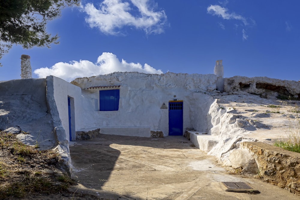 a white building with blue doors