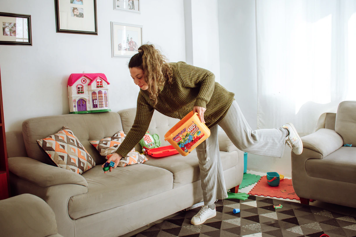 A professional cleaner ready for work in a bright home.