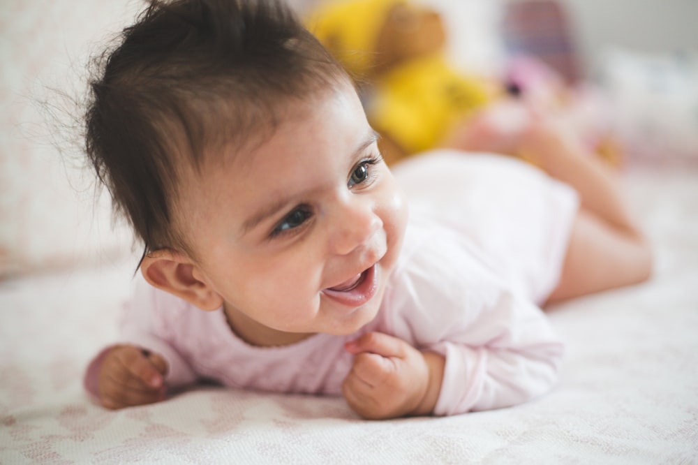 a baby lying on the ground