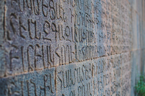 a stone wall with writing on it