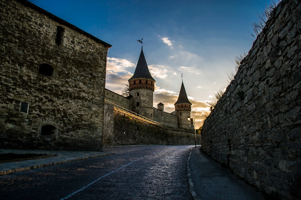 a stone building with a steeple with Akershus Fortress in the background