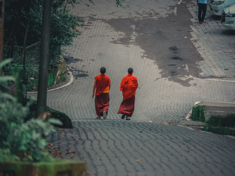 a couple of men walking down a street