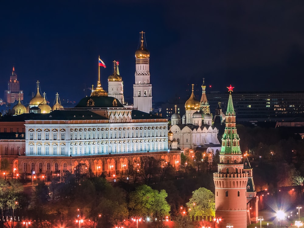 a large building with towers and a flag on top