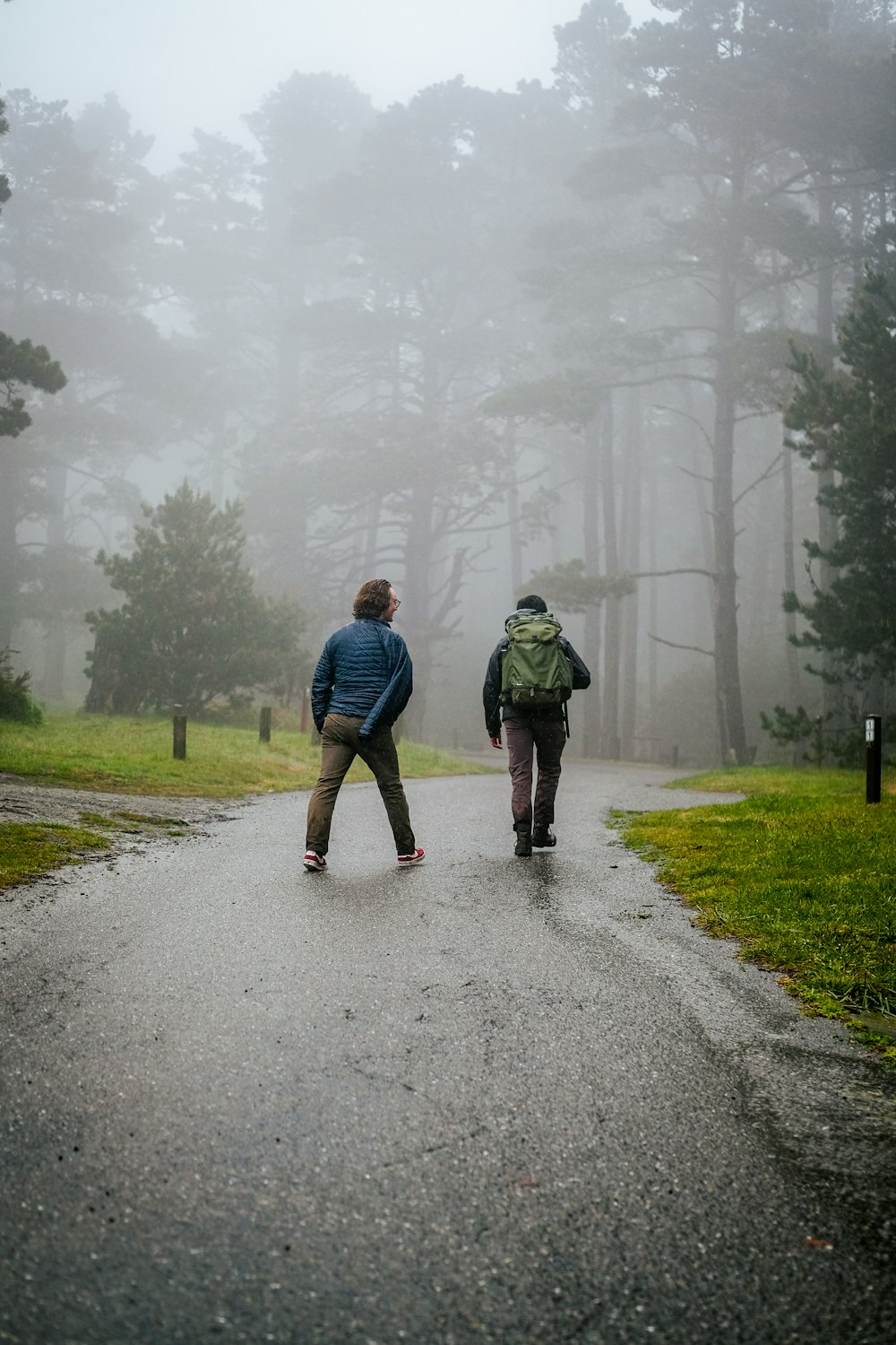 two people walking on a road