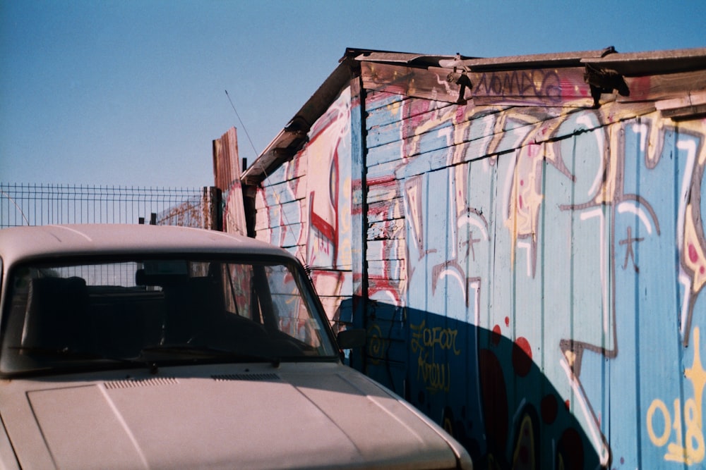 a car parked next to a large container