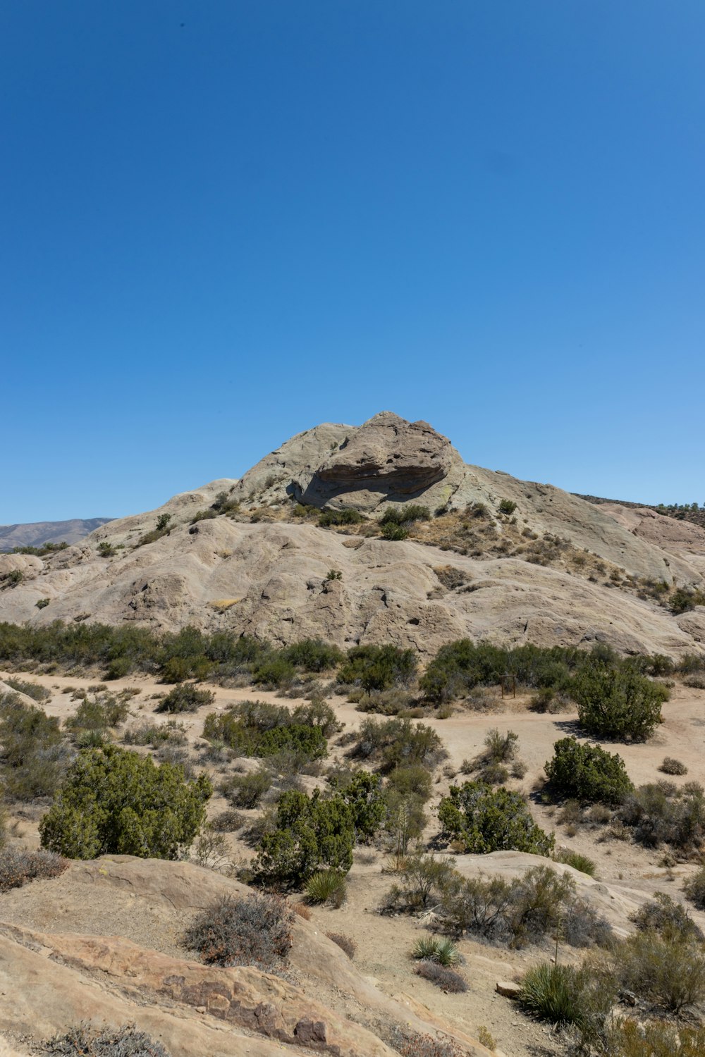 a desert landscape with a rock formation