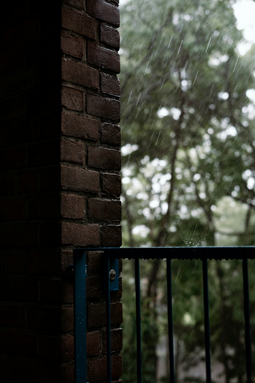 a brick wall with a blue gate