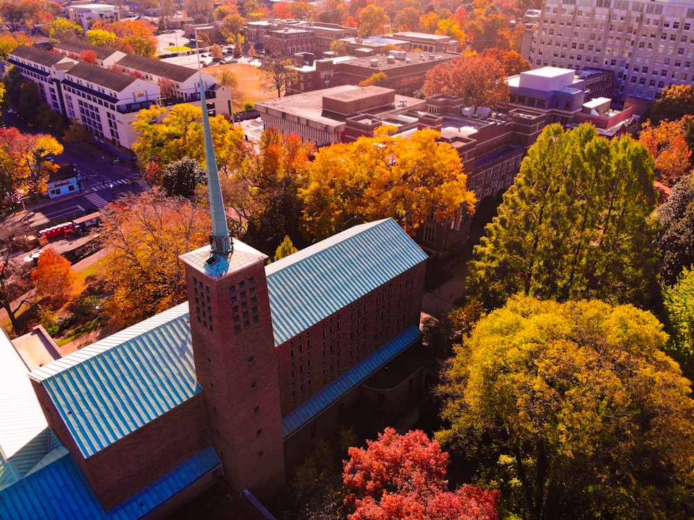 a building with a tower and trees around it