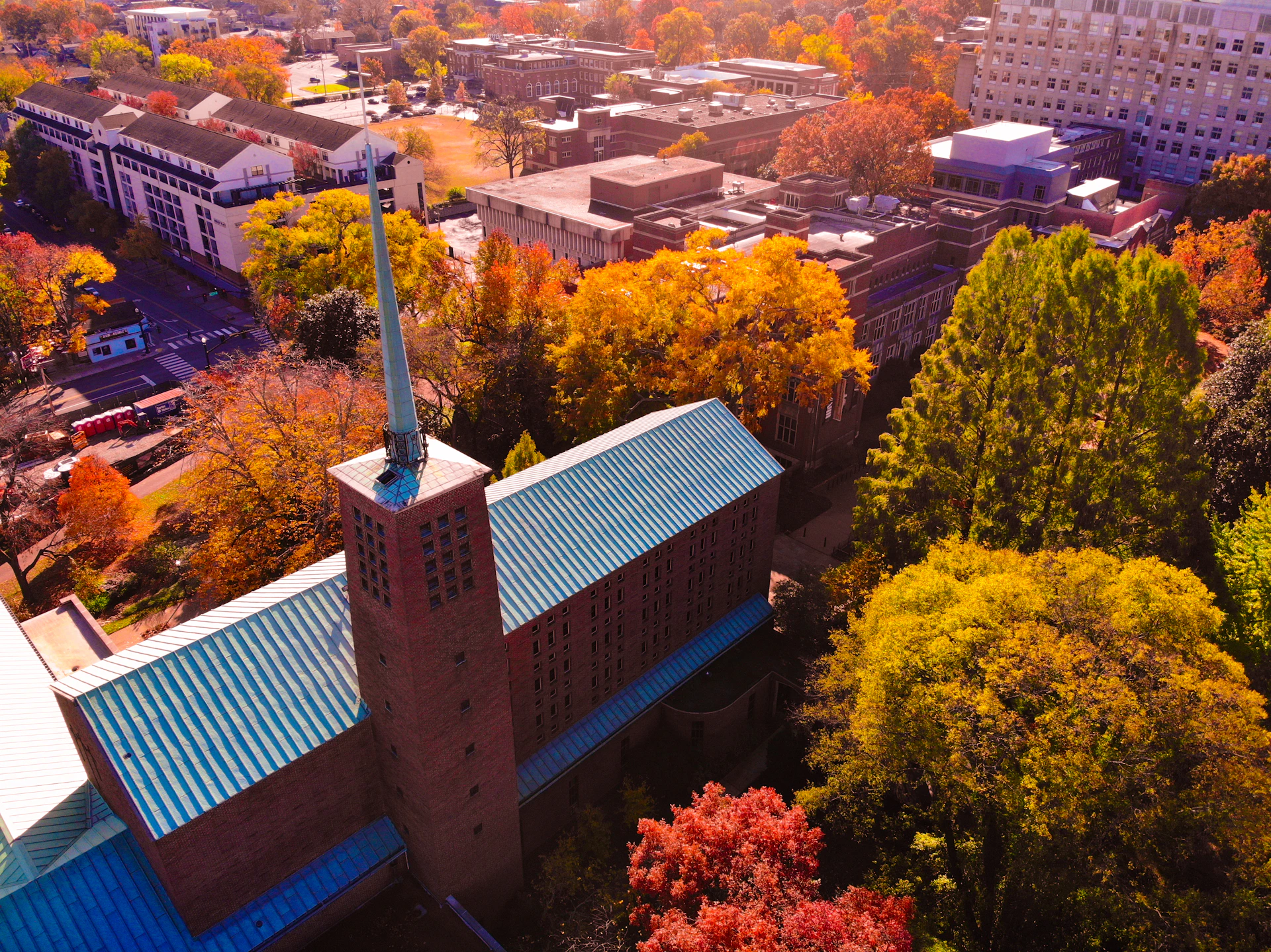 a building with a tower and trees around it