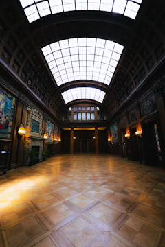 Wide-angle photo of the grand main hall with polished wooden floors and classic Masonic decor.