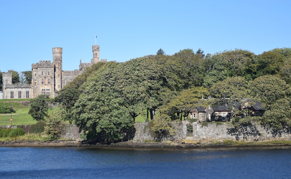 a building on a hill by a body of water