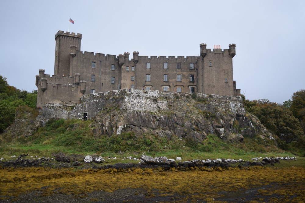 a castle on a hill with Dunvegan Castle in the background