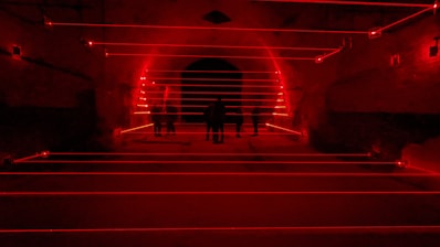 Office space converted into a lively laser tag arena with employees playing.