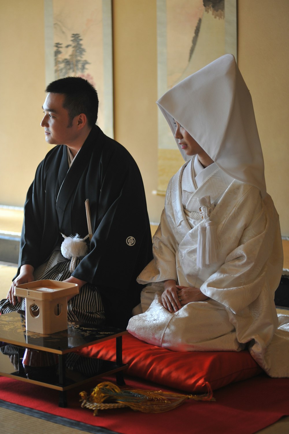 a person in a turban sitting next to a person in a robe