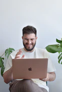 a man holding a laptop