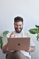 a man holding a laptop